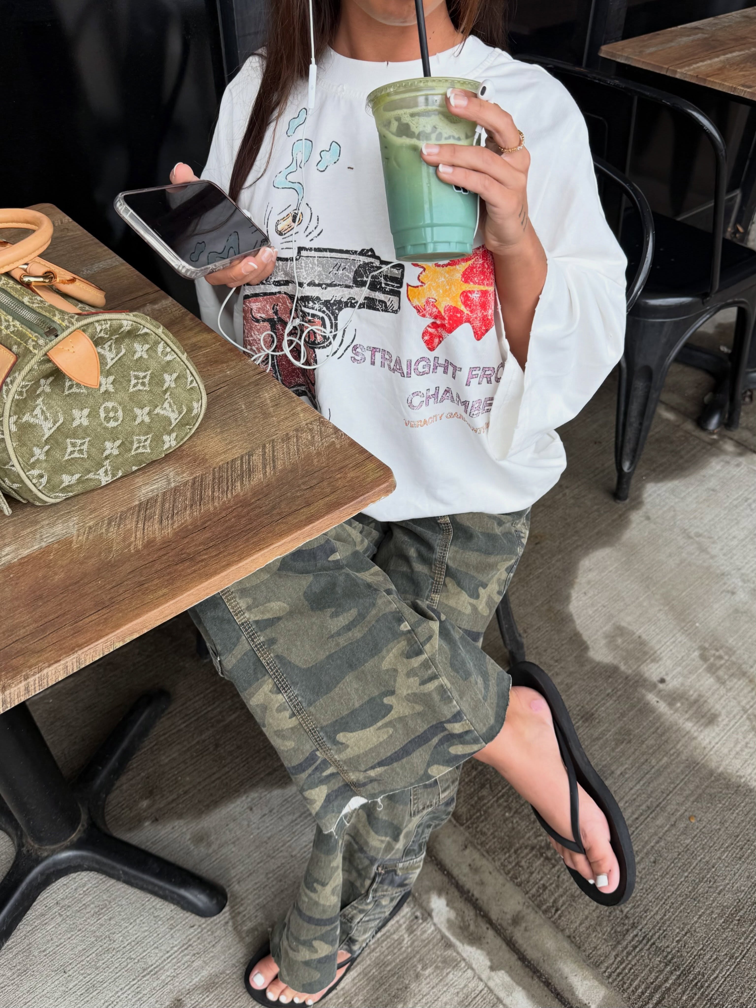 Camo tee detail with peace-sign mark