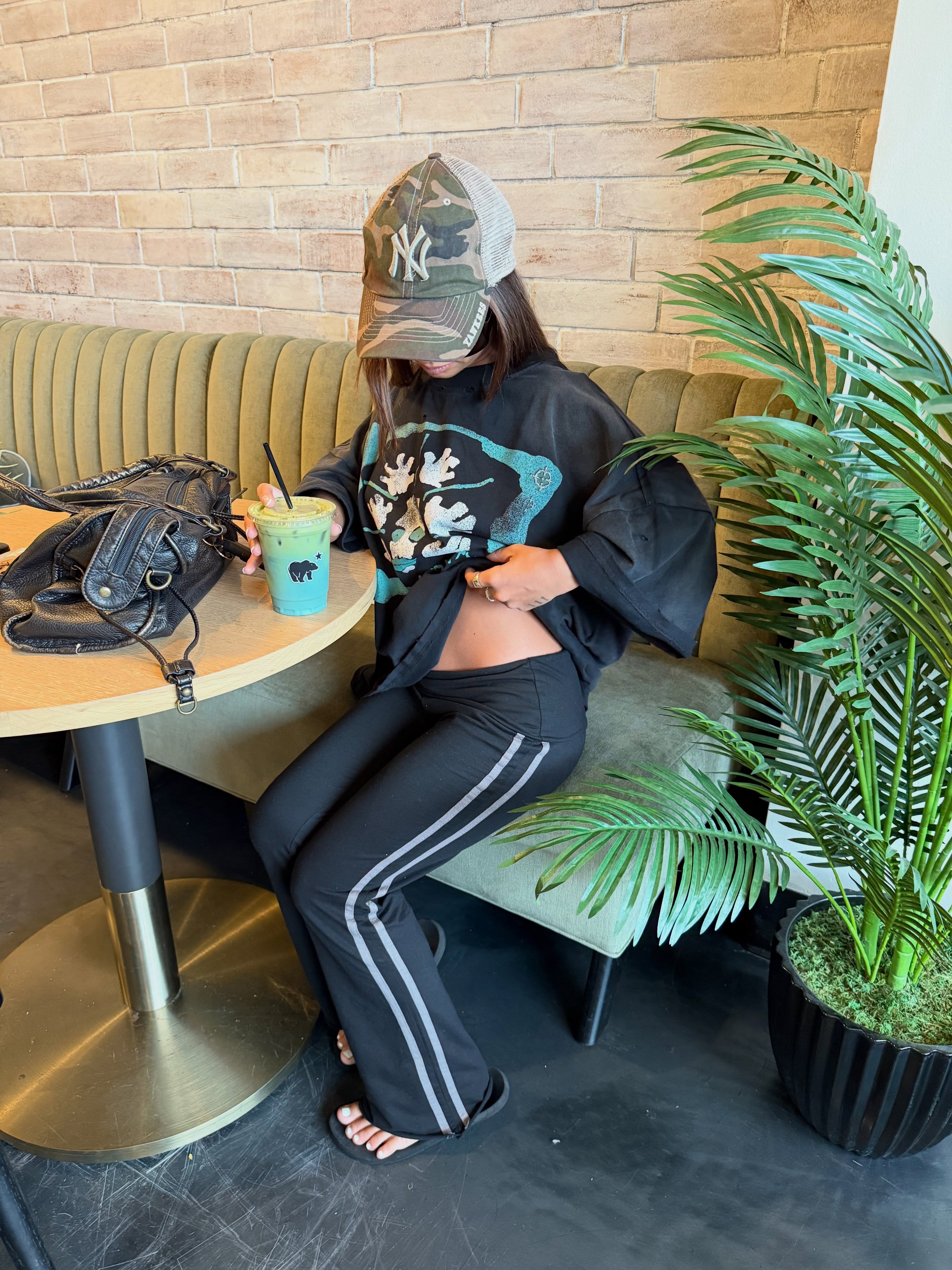Model in forest with camo tee